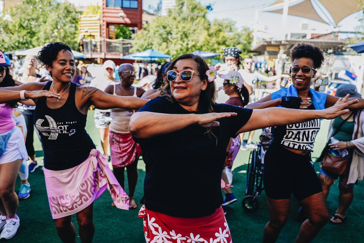 People participate in a Hawaiian themed Zumba session during a fundraiser for victims of the Ma ...