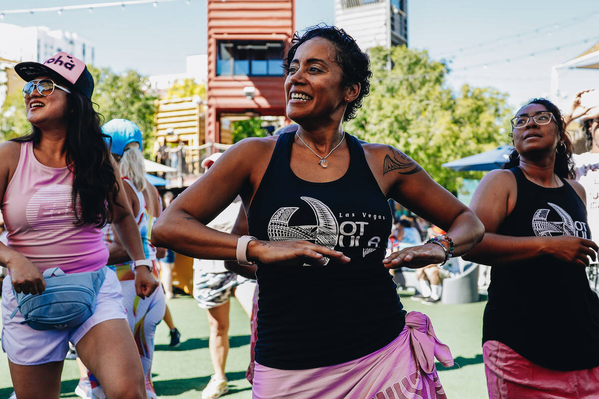 People participate in a Hawaiian themed Zumba session during a fundraiser for victims of the Ma ...