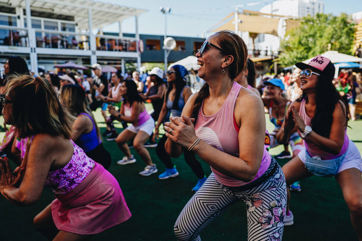 People participate in a Hawaiian themed Zumba session during a fundraiser for victims of the Ma ...