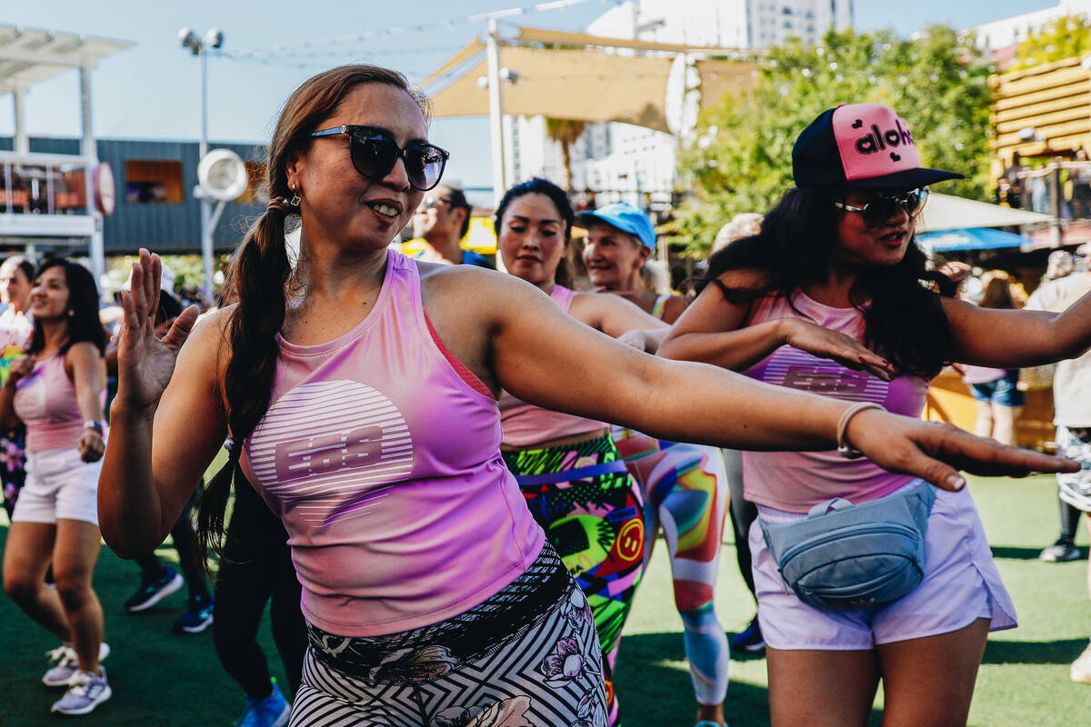 People participate in a Hawaiian themed Zumba session during a fundraiser for victims of the Ma ...