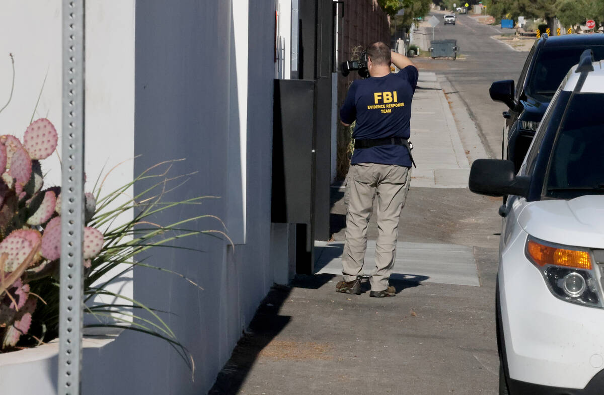 FBI personnel investigate at a home on the corner of West La Madre Way and Conough Lane in Las ...