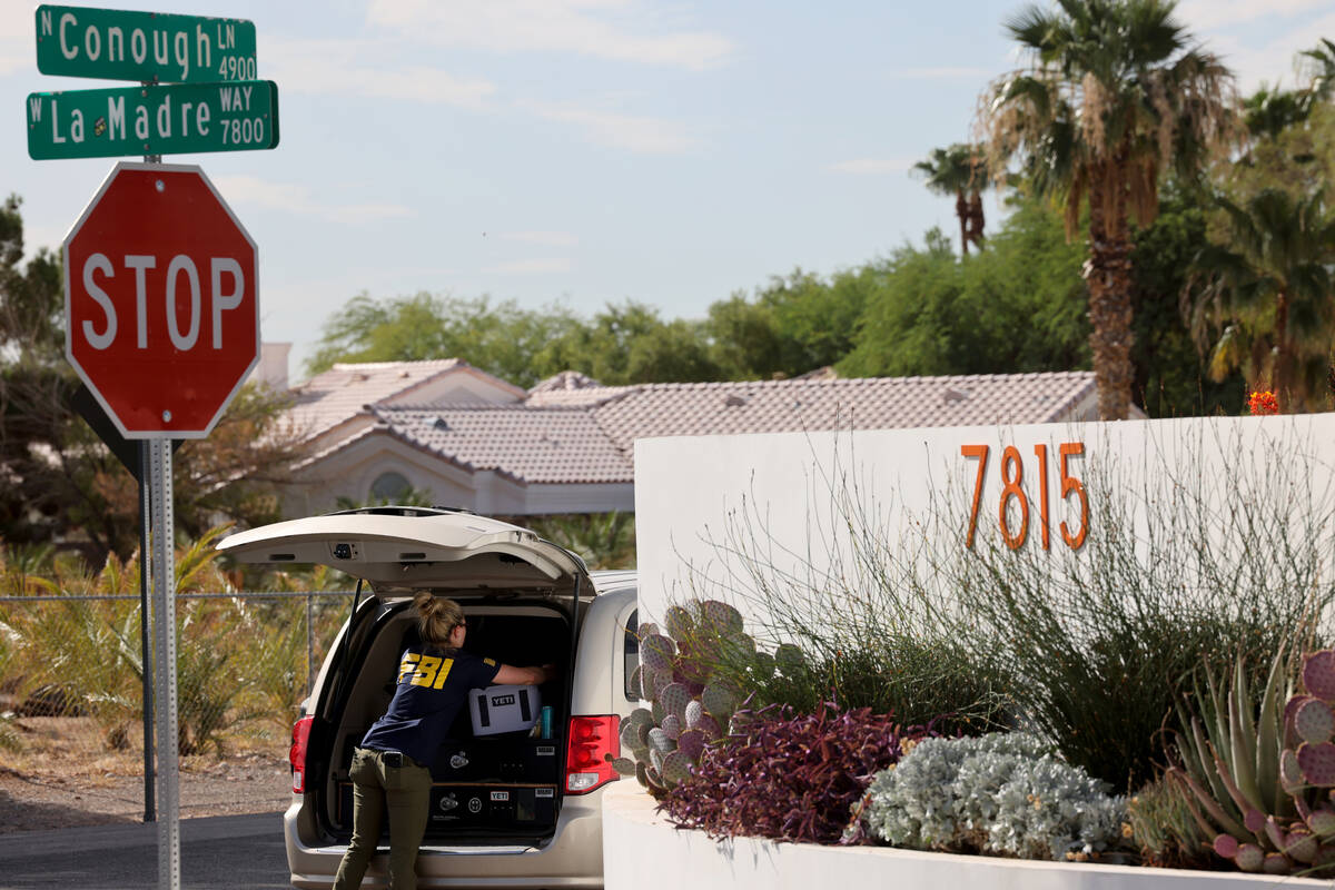 FBI personnel investigate at a home on the corner of West La Madre Way and Conough Lane in Las ...