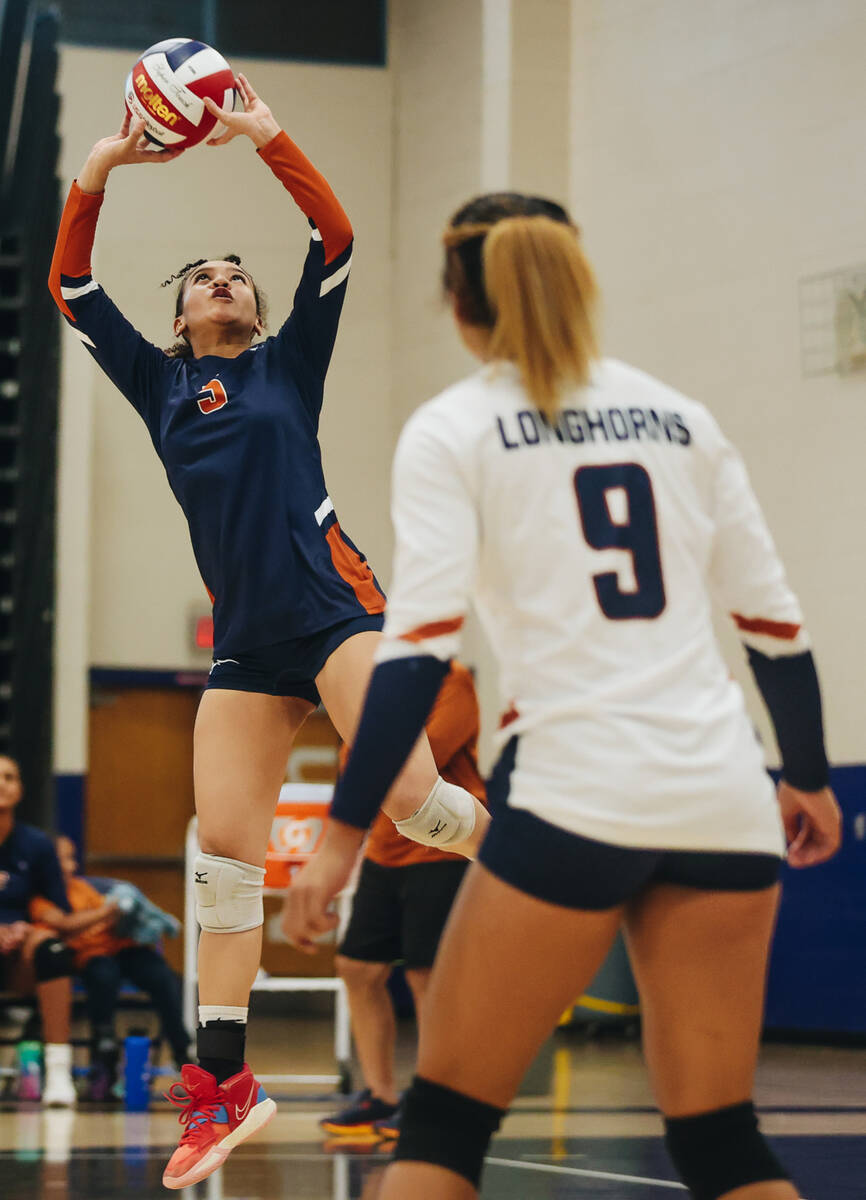 Legacy setter Miy’aja Diggs (5) jumps up for an assist as outside hitter and fellow team ...