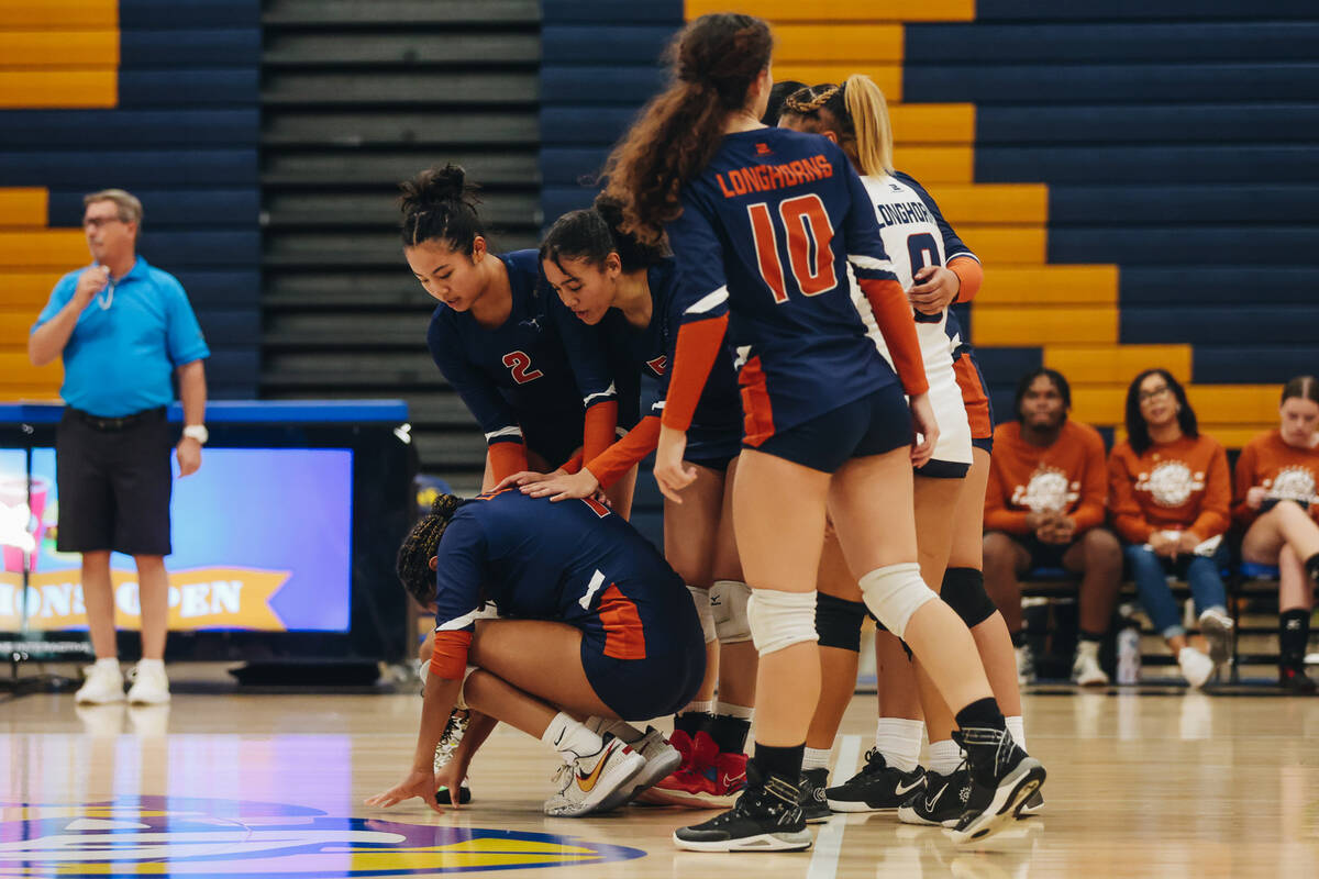 Legacy middle Kiana Peterson (left) is comforted by her teammates after giving a point up to Si ...
