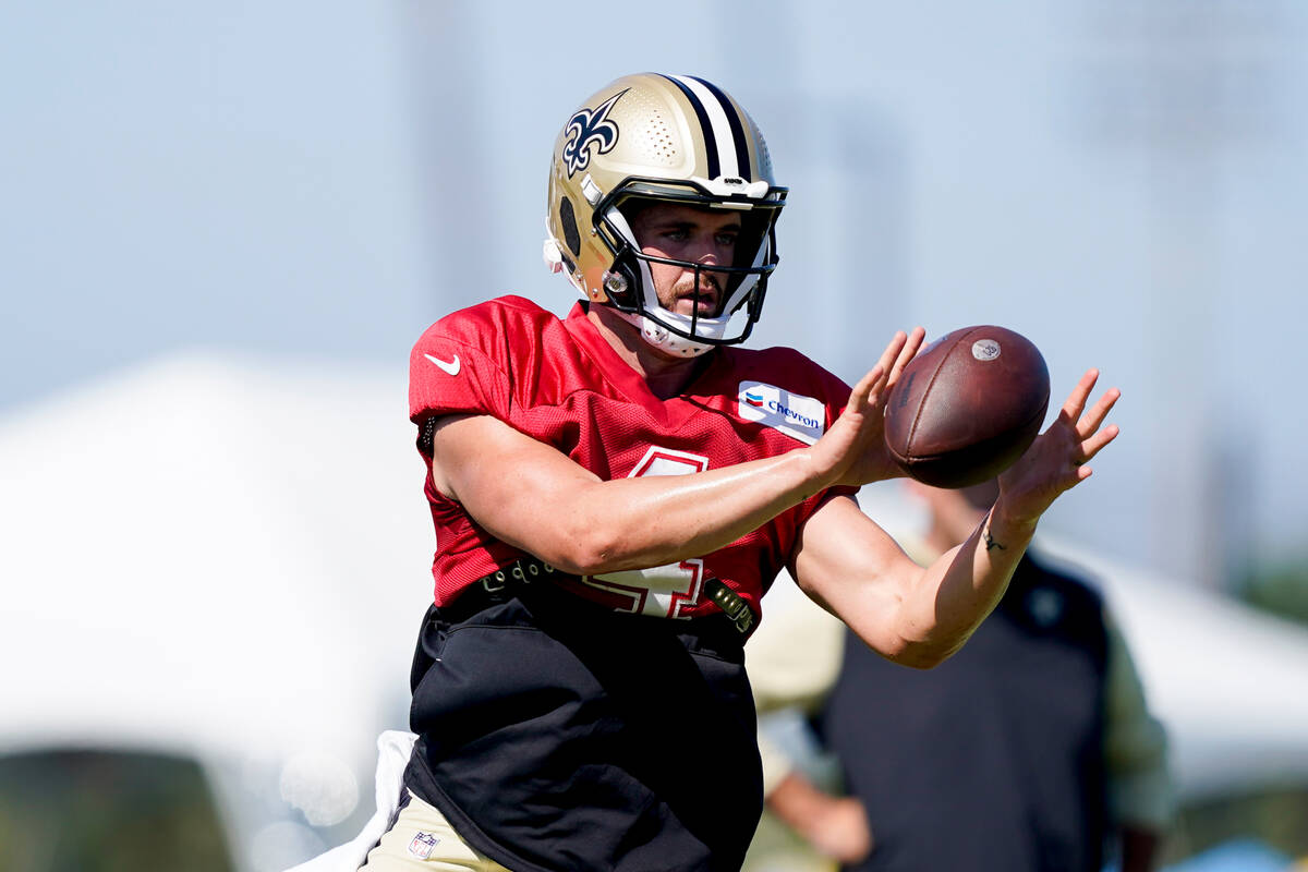 New Orleans Saints quarterback Derek Carr takes a snap during a joint NFL football practice wit ...