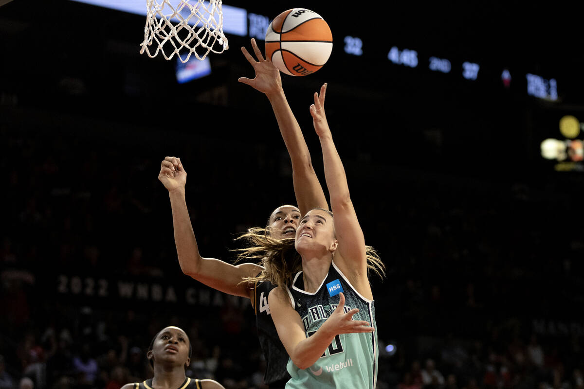 New York Liberty guard Sabrina Ionescu (20) shoots against Las Vegas Aces center Kiah Stokes, b ...