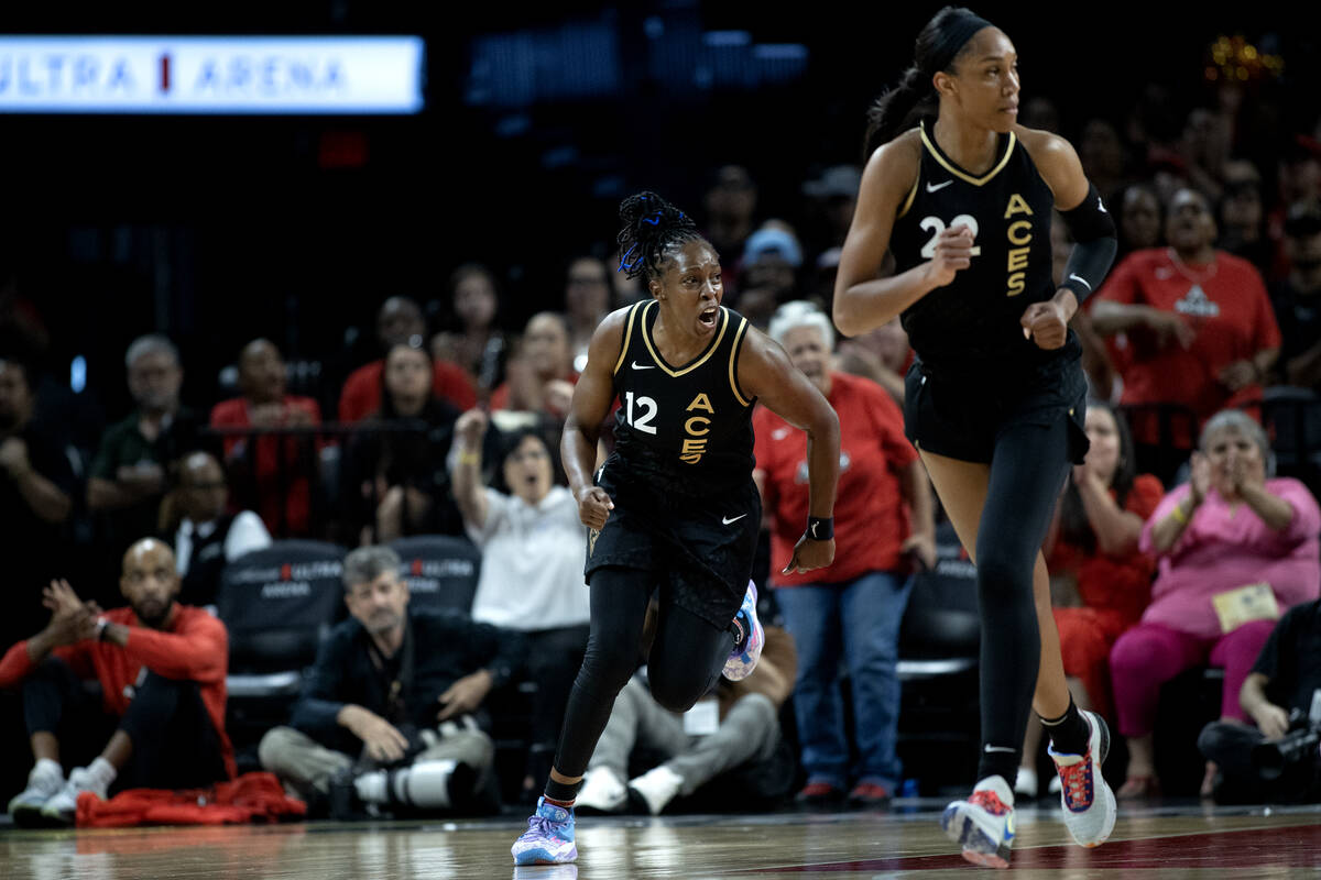 Las Vegas Aces guard Chelsea Gray (12) celebrates after scoring while forward A'ja Wilson (22) ...