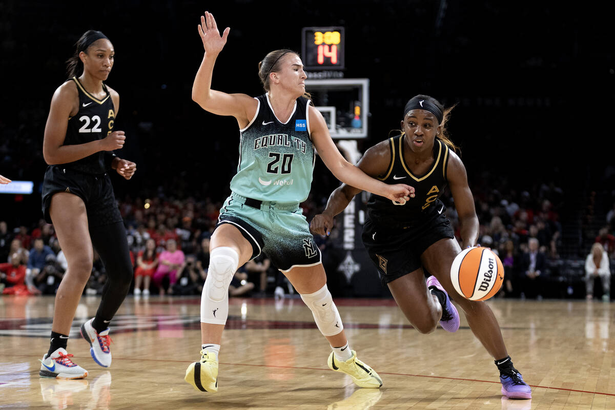 Las Vegas Aces guard Jackie Young (0) drives toward the hoop while New York Liberty guard Sabri ...