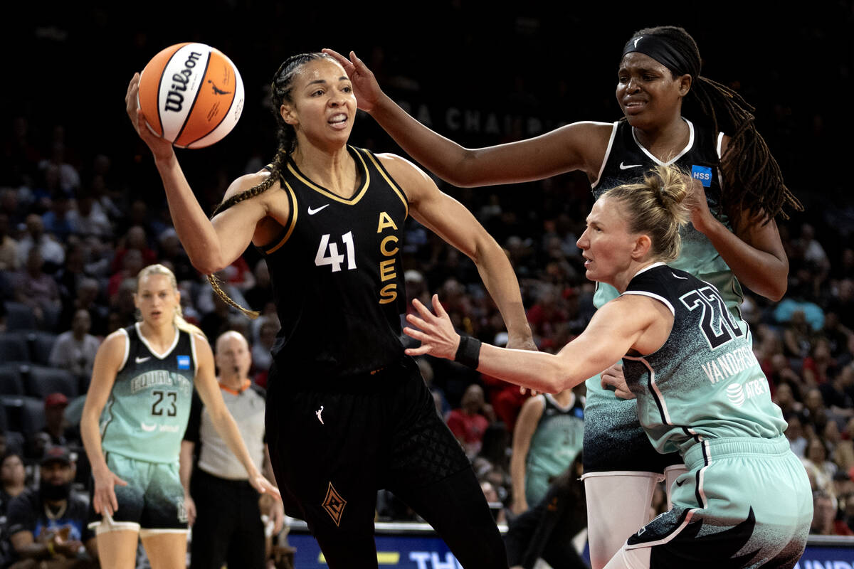 Las Vegas Aces center Kiah Stokes (41) passes while New York Liberty guard Courtney Vandersloot ...