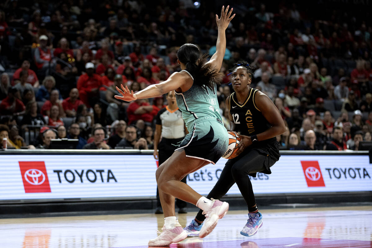 Las Vegas Aces guard Chelsea Gray (12) prepares to shoot while New York Liberty forward Betnija ...