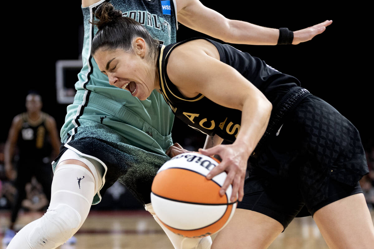 Las Vegas Aces guard Kelsey Plum (10) grimaces while New York Liberty guard Courtney Vandersloo ...