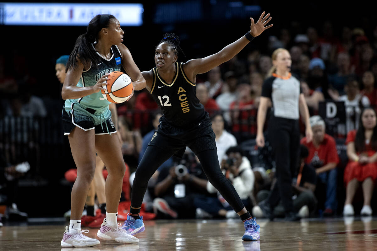 Las Vegas Aces guard Chelsea Gray (12) defends against New York Liberty forward Betnijah Laney ...