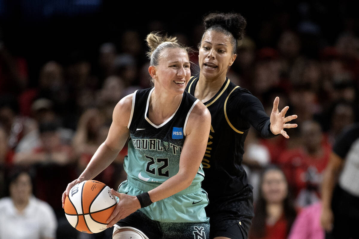 Las Vegas Aces forward Alysha Clark (7) guards New York Liberty guard Courtney Vandersloot (22) ...