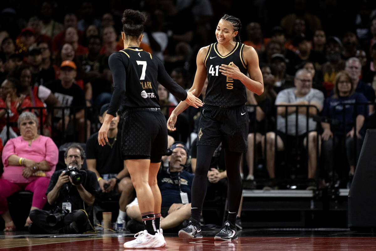 Las Vegas Aces forward Alysha Clark (7) congratulates center Kiah Stokes (41) on a block during ...