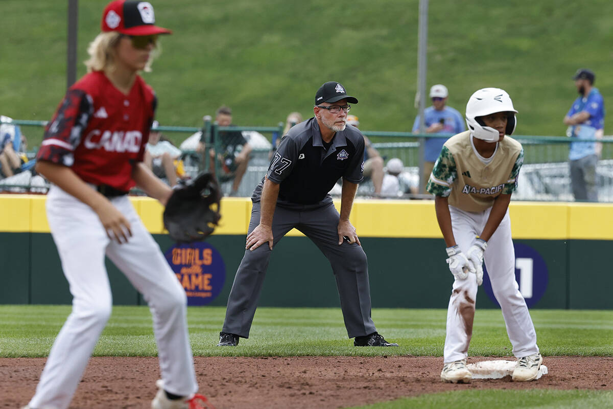 Second base umpire Ben Sprague of Las Vegas, center, watches play during the Little League Worl ...