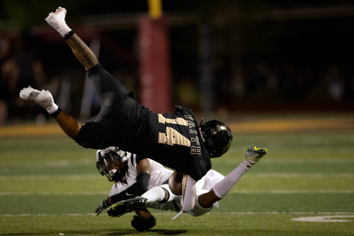 Faith Lutheran running back Cale Breslin (14) is taken down by Palo Verde cornerback Eyan Edwar ...