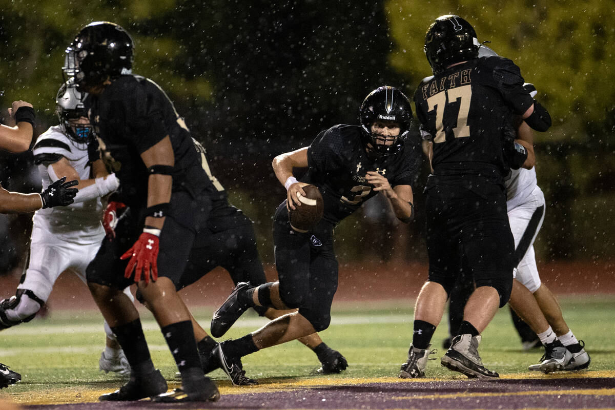 Faith Lutheran quarterback Garyt Odom (3) finds an opening to run the ball during the second ha ...