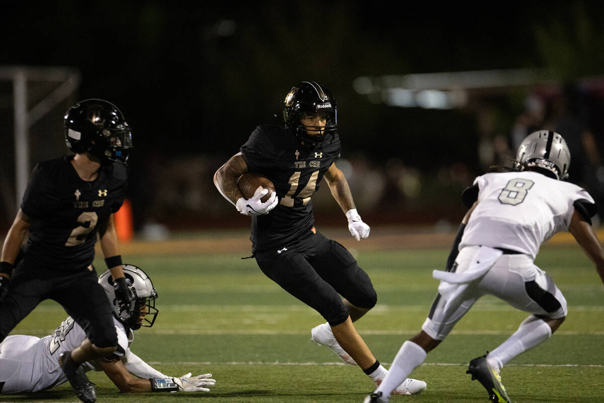Faith Lutheran running back Cale Breslin (14) runs the ball while Palo Verde cornerback Eyan Ed ...