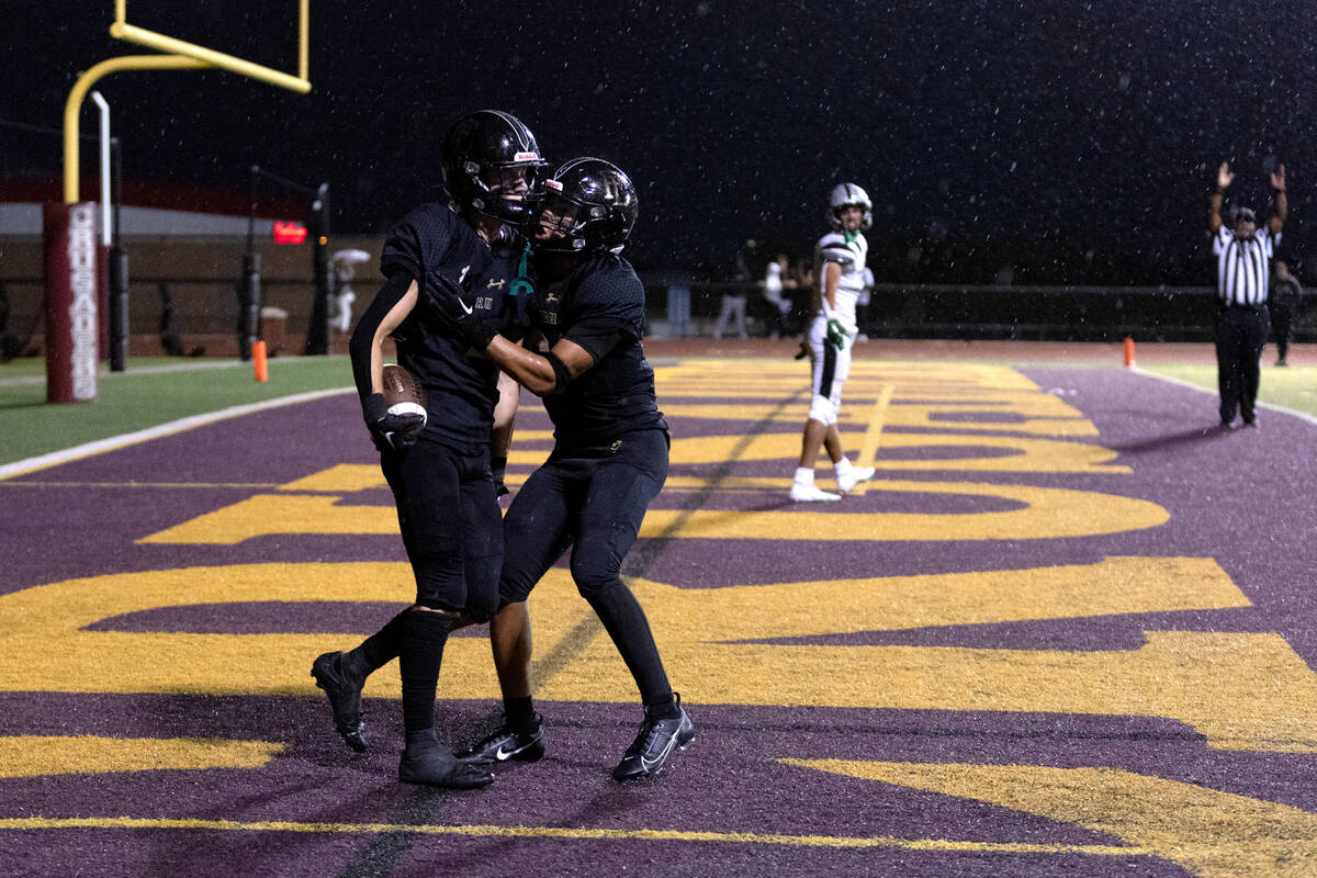 Faith Lutheran’s Mason Aday, left, and Garyt Odom celebrate Aday’s touchdown duri ...