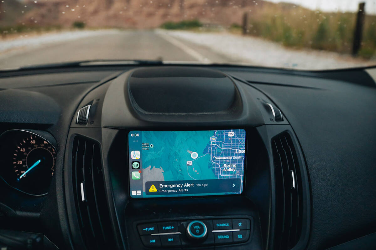 An emergency alert for flash flooding due to storms is displayed on a car screen for the Red Ro ...