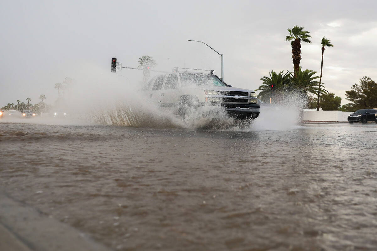 Cars battle rush hour traffic amidst a flash flood warning along Eastern Ave and Robindale Road ...