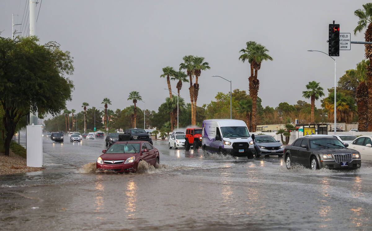 Cars battle rush hour traffic amidst flash flood along Eastern Avenue and Robindale Road on Fri ...