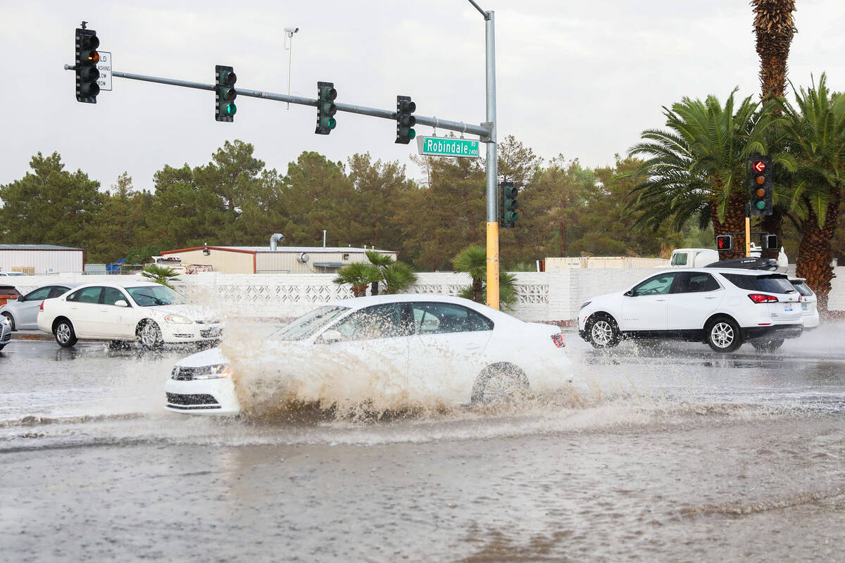 Cars battle rush hour traffic amidst flash flood warning along Eastern Avenue and Robindale Roa ...