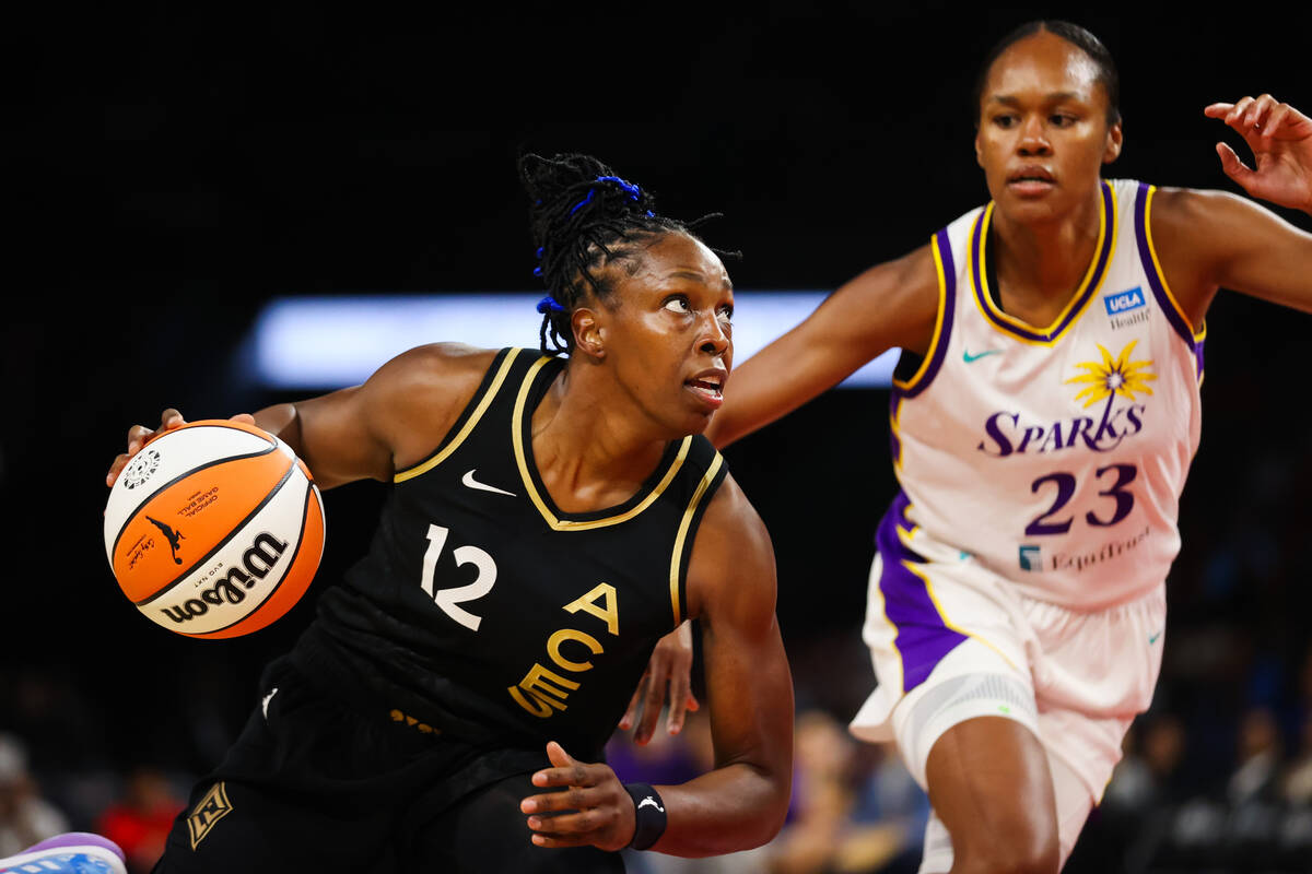 Las Vegas Aces guard Chelsea Gray (12) rushes the ball past Los Angeles Sparks forward Azura St ...