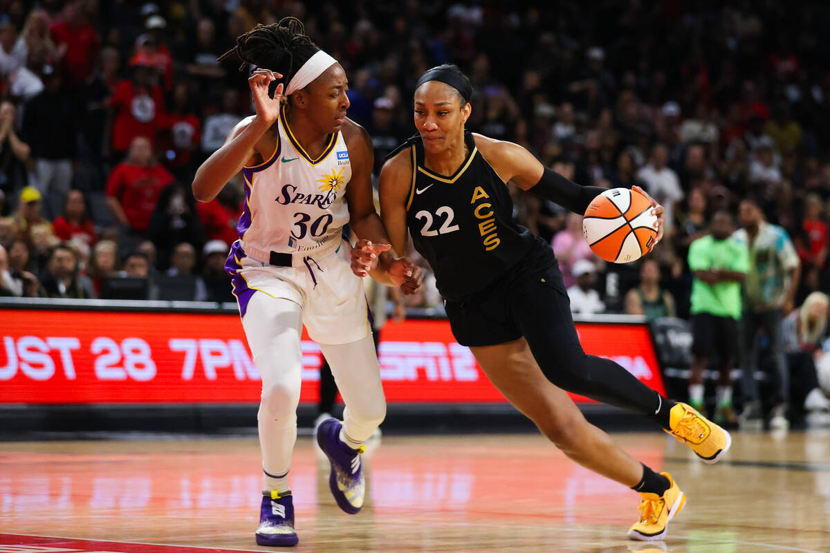 Las Vegas Aces forward A'ja Wilson (22) drives the ball past Los Angeles Sparks forward Nneka O ...