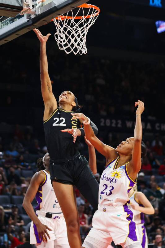 Las Vegas Aces forward A'ja Wilson (22) shoots a layup around Los Angeles Sparks forward Azura ...