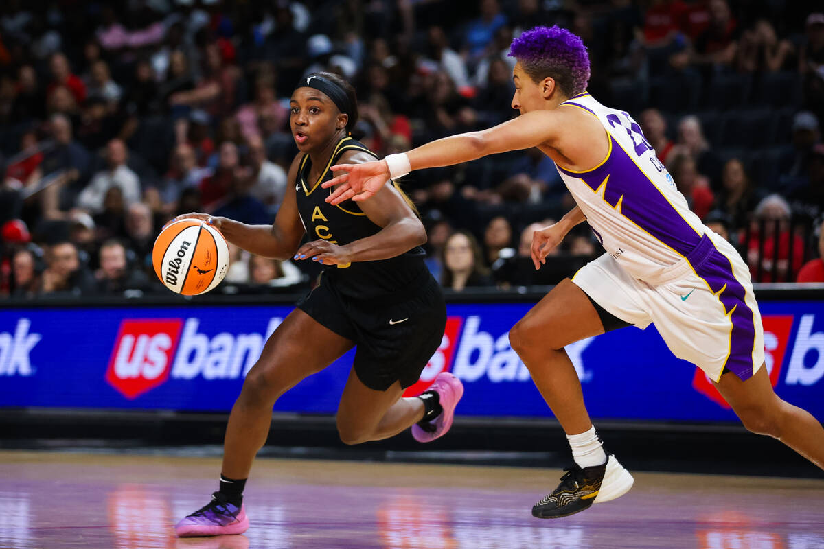 Las Vegas Aces guard Jackie Young (0) drives to the net past Los Angeles Sparks guard Layshia C ...