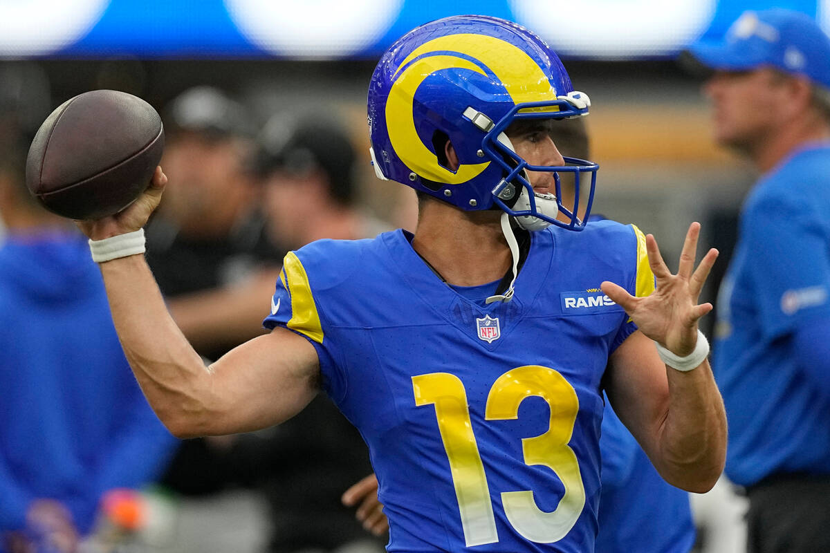 Los Angeles Rams quarterback Stetson Bennett warms up before a preseason NFL football game agai ...