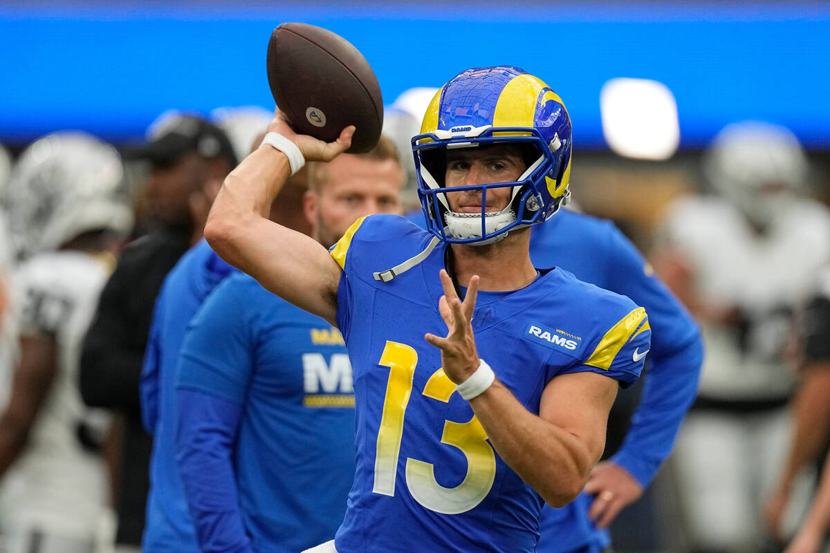 Los Angeles Rams quarterback Stetson Bennett warms up before a preseason NFL football game agai ...