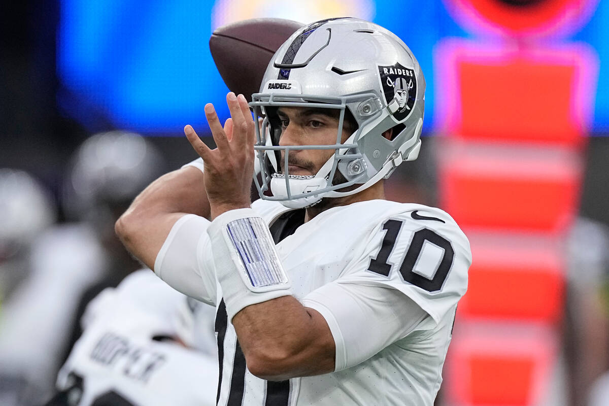 Las Vegas Raiders quarterback Jimmy Garoppolo throws during the first half of a preseason NFL f ...