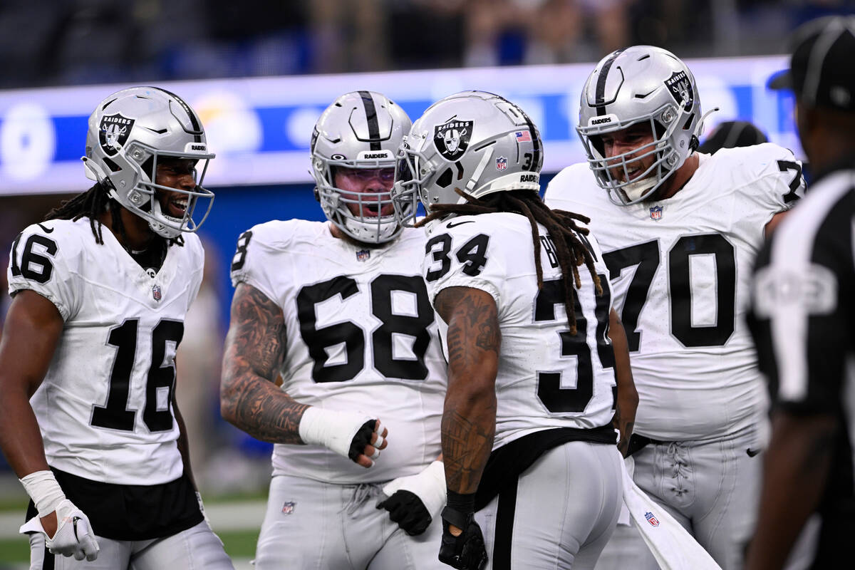 Las Vegas Raiders running back Brandon Bolden (34) celebrates his touchdown run with teammates ...