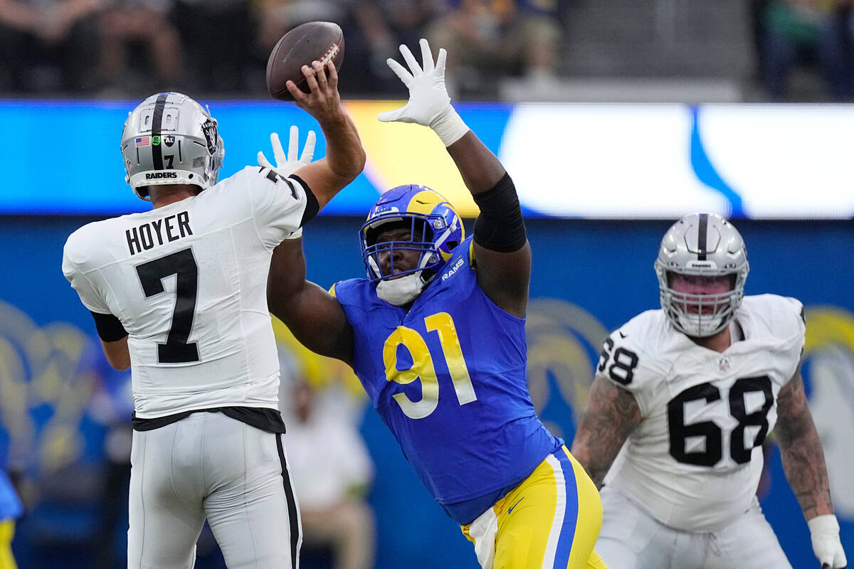 Los Angeles Rams defensive tackle Kobie Turner pressures Las Vegas Raiders quarterback Brian Ho ...
