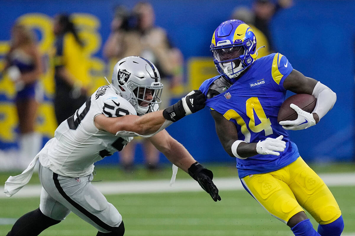 Las Vegas Raiders linebacker Luke Masterson, left, tackles Los Angeles Rams wide receiver Tyler ...