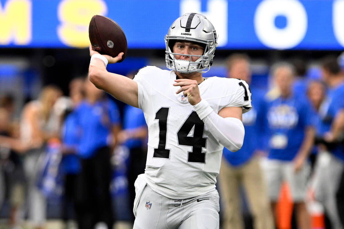Las Vegas Raiders quarterback Chase Garbers warms up before a preseason NFL football game again ...