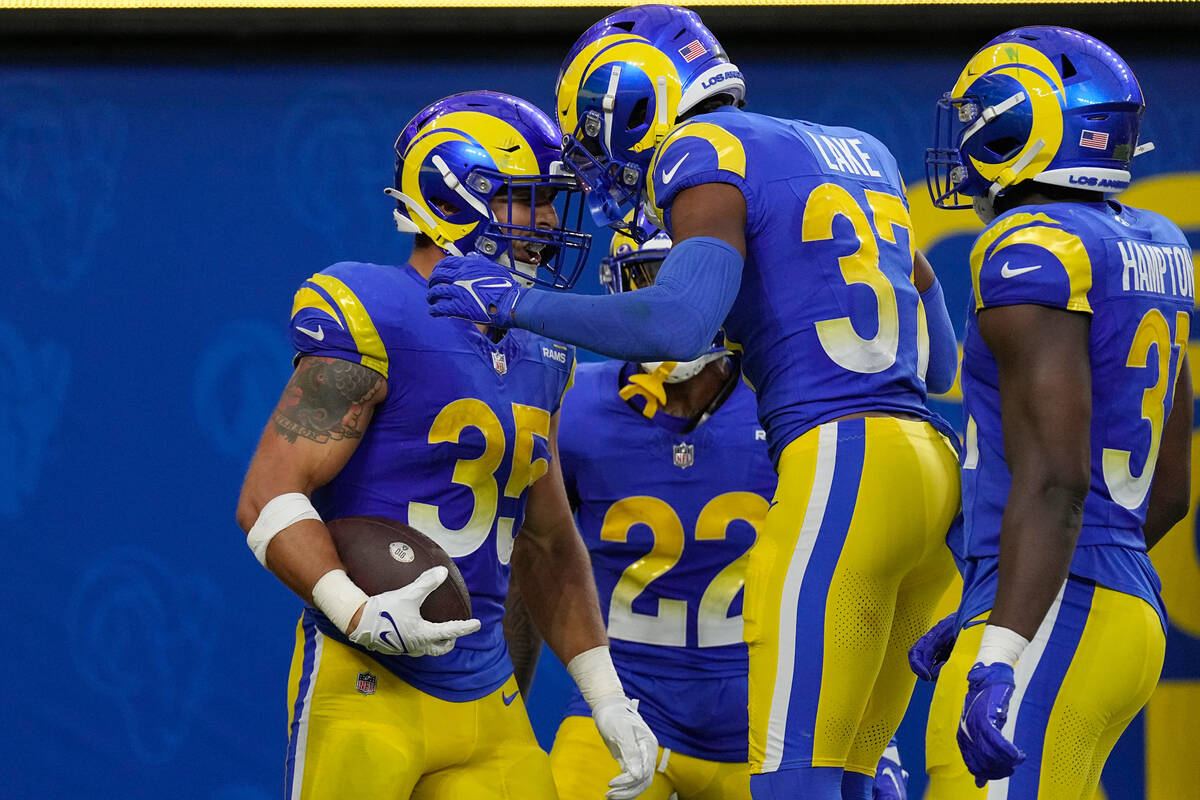 Los Angeles Rams linebacker Jacob Hummel, left, celebrates his interception for a touchdown wit ...