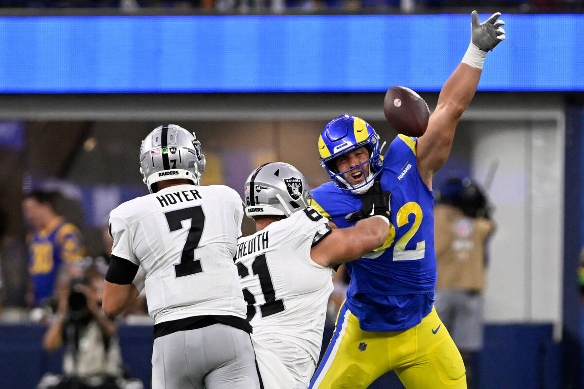 Los Angeles Rams defensive end Jonah Williams, right, blocks a pass from Las Vegas Raiders quar ...