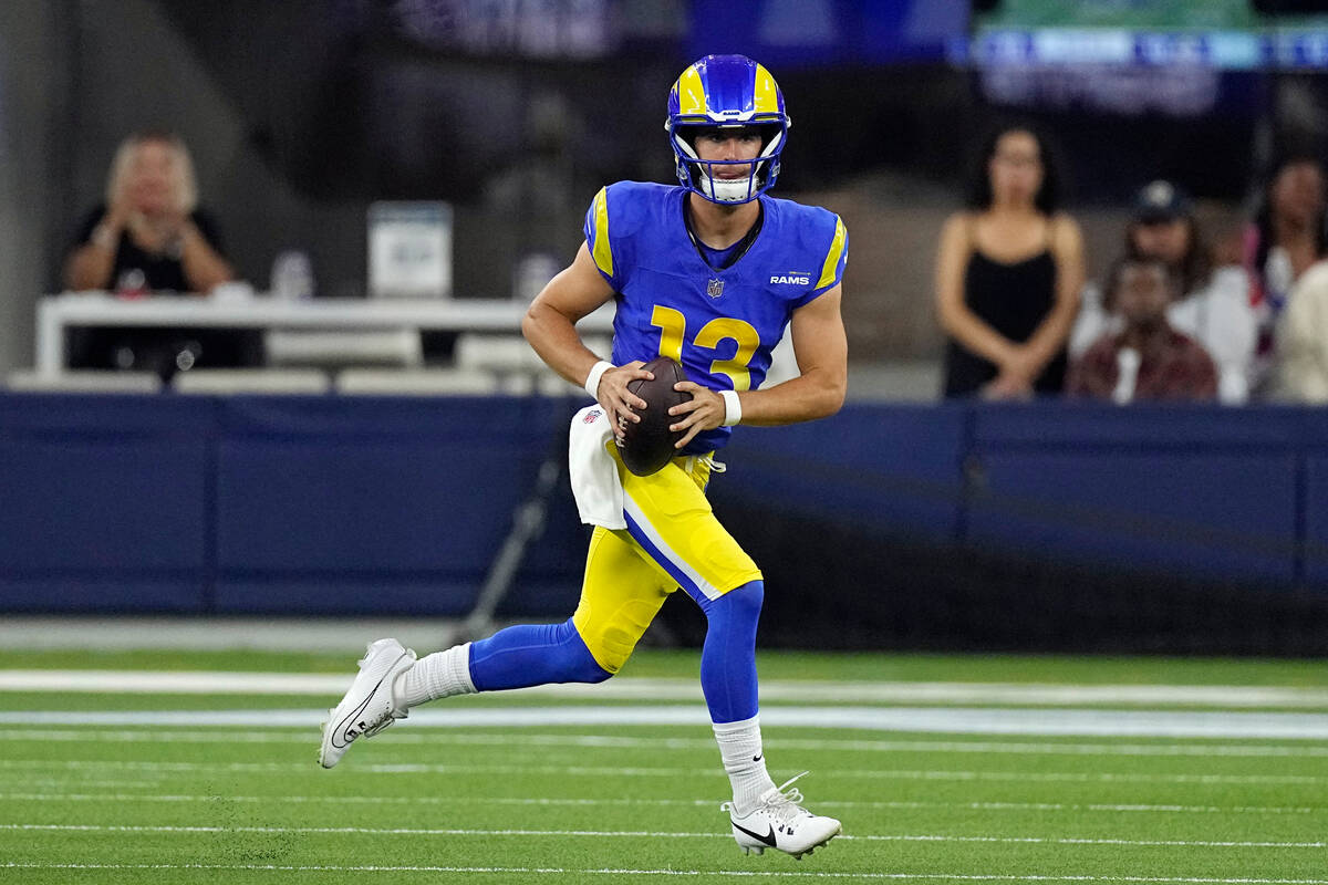 Los Angeles Rams quarterback Stetson Bennett runs against the Las Vegas Raiders during the firs ...