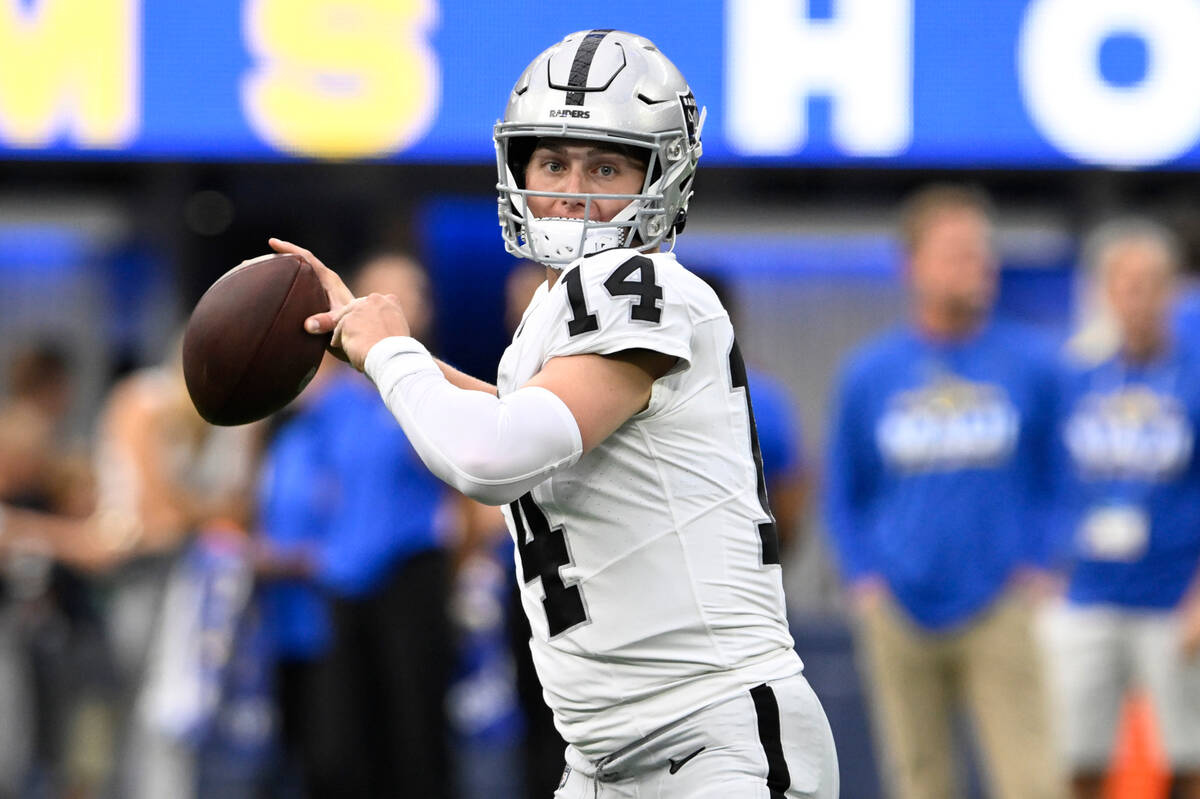 Las Vegas Raiders quarterback Chase Garbers warms up before a preseason NFL football game again ...