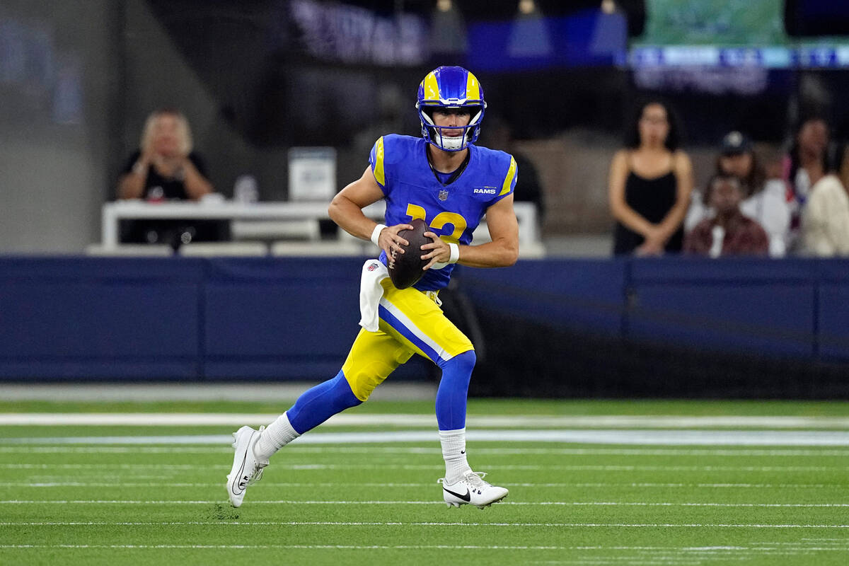 Los Angeles Rams quarterback Stetson Bennett runs against the Las Vegas Raiders during the firs ...