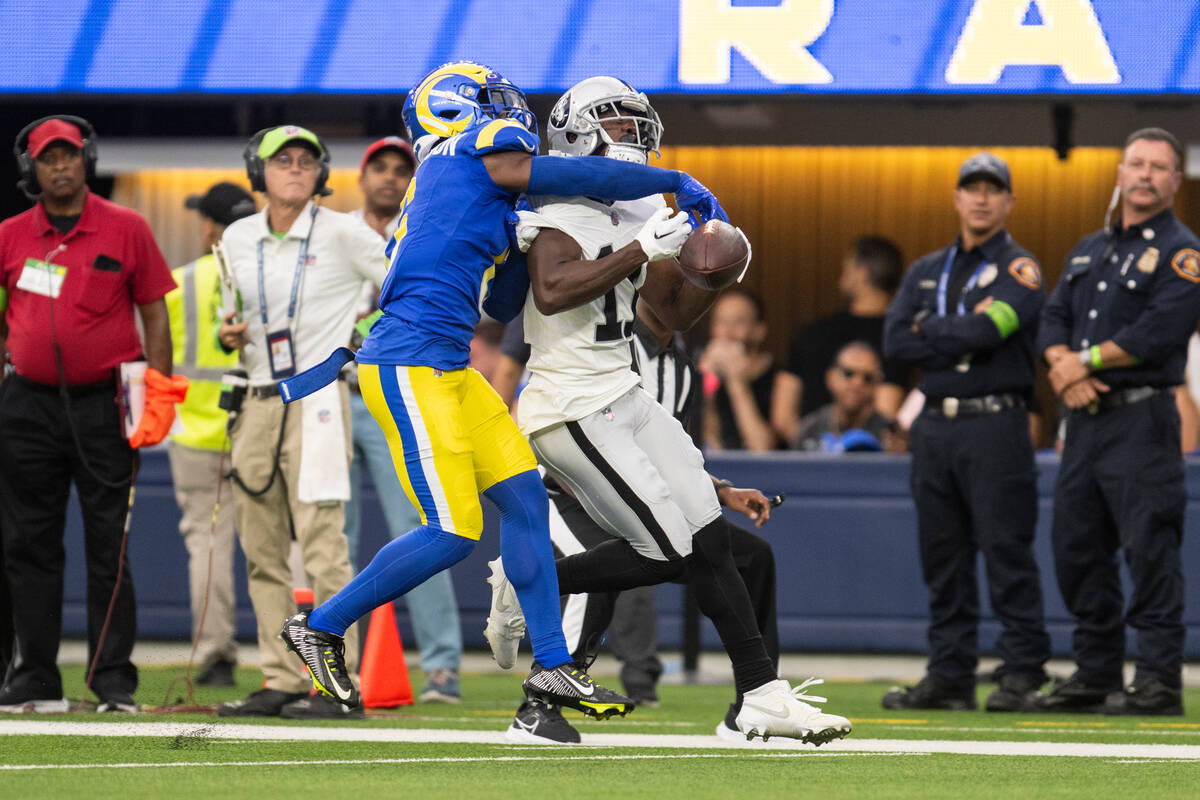 Los Angeles Rams cornerback Tre Tomlinson (6) stops a pass intended to Las Vegas Raiders wide r ...