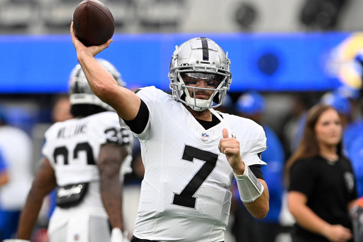 Las Vegas Raiders quarterback Brian Hoyer warms up before a preseason NFL football game against ...