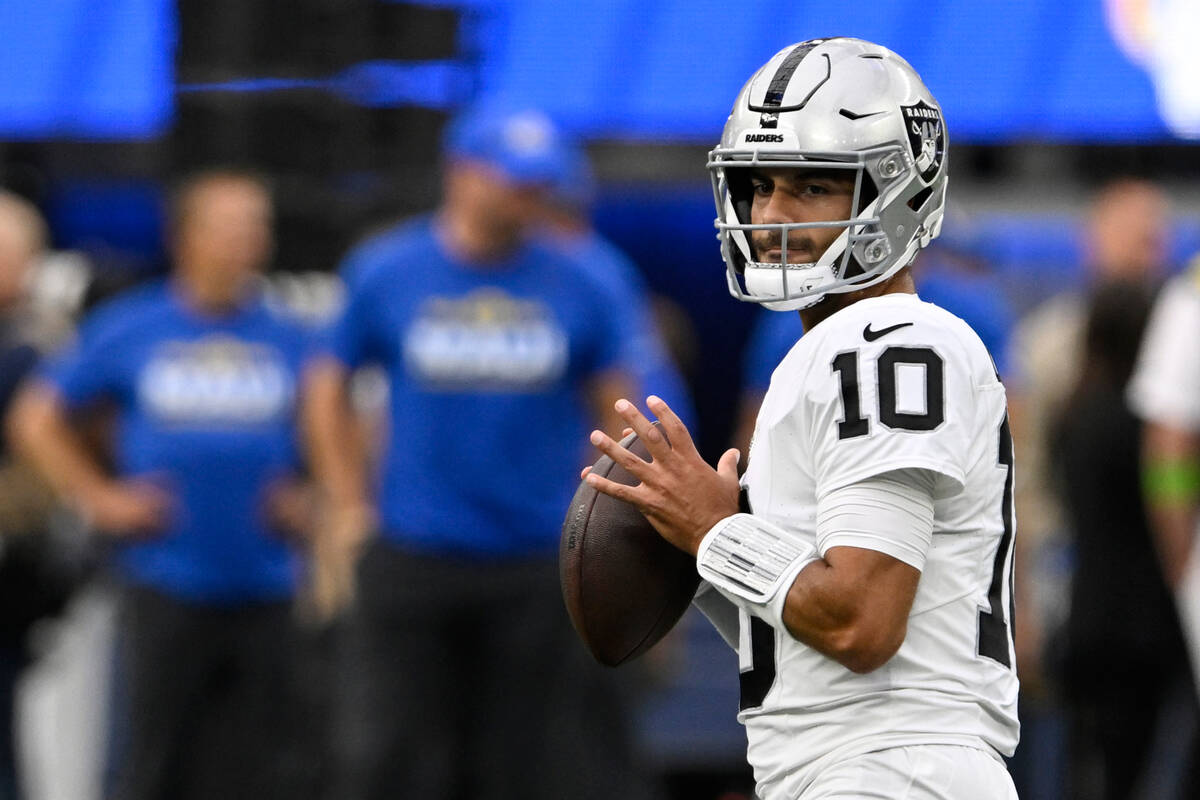 Las Vegas Raiders quarterback Jimmy Garoppolo warms up before a preseason NFL football game aga ...