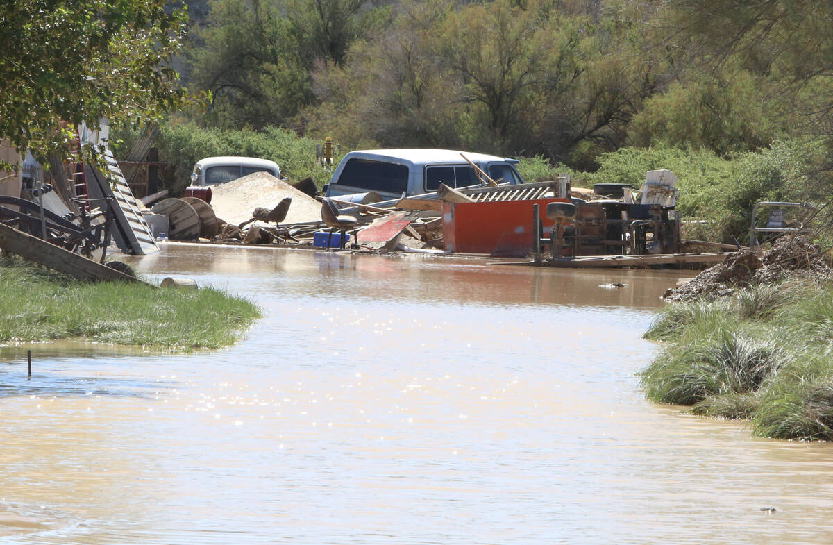 Flood damaged vehicles are seen next to debris, on Saturday, Sept. 27, 2014, at Warm Springs in ...