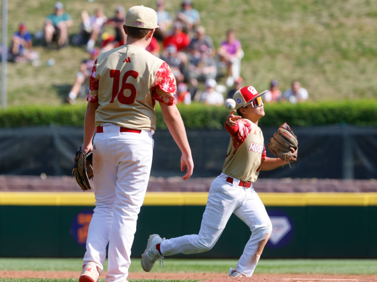 The Henderson All-Stars third baseman David Edwards throw for the out to first as pitcher Logan ...