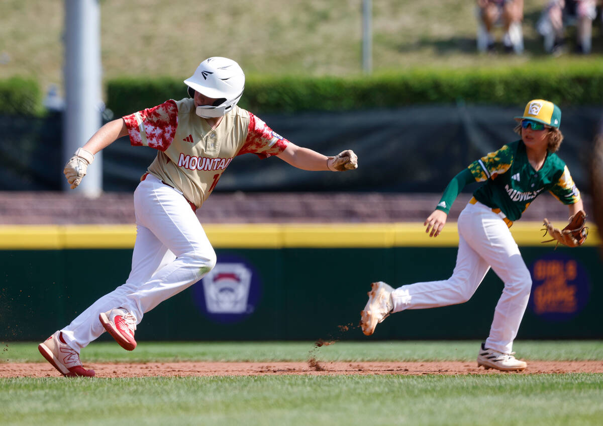 The Henderson All-Stars third baseman Logan Levasseur runs back to first after a prolonged run ...