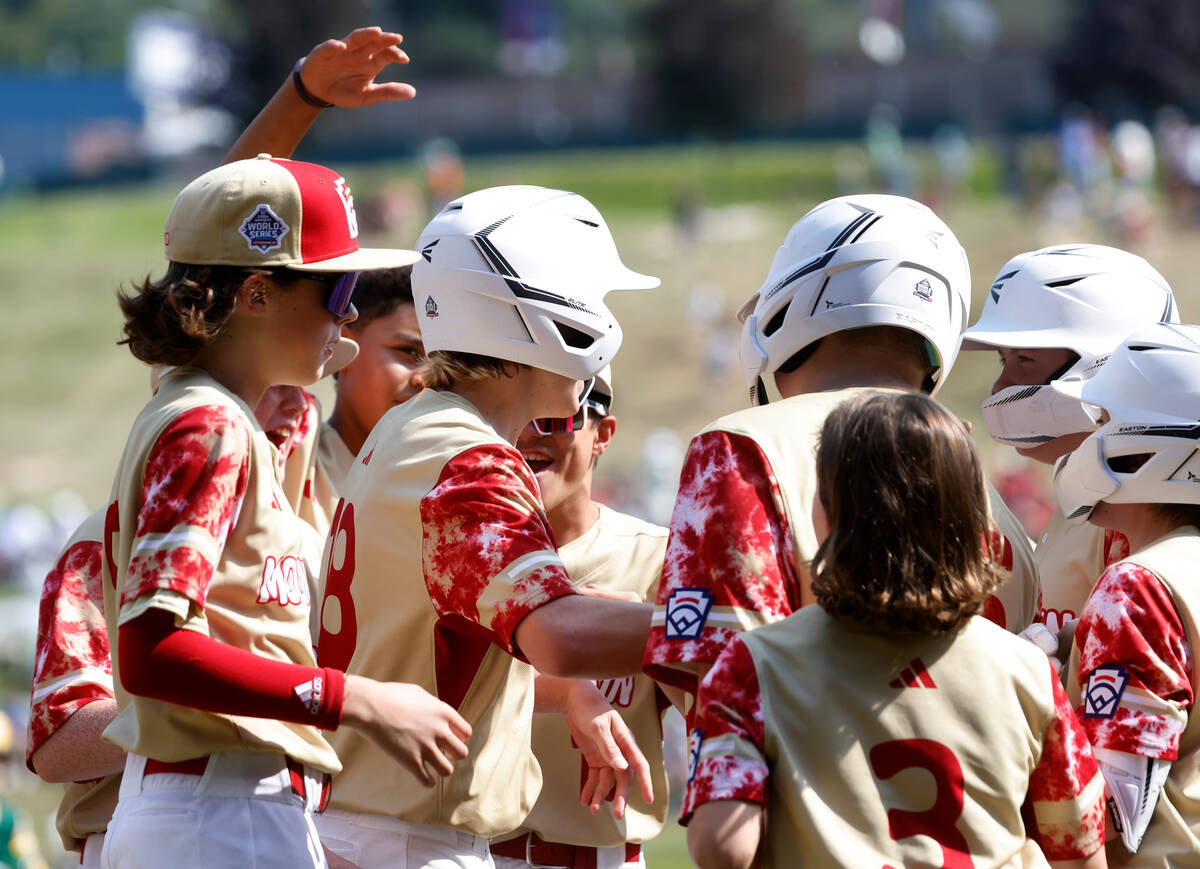The Henderson All-Stars centerfield Nolan Gifford, center, celebrates with his teammates after ...